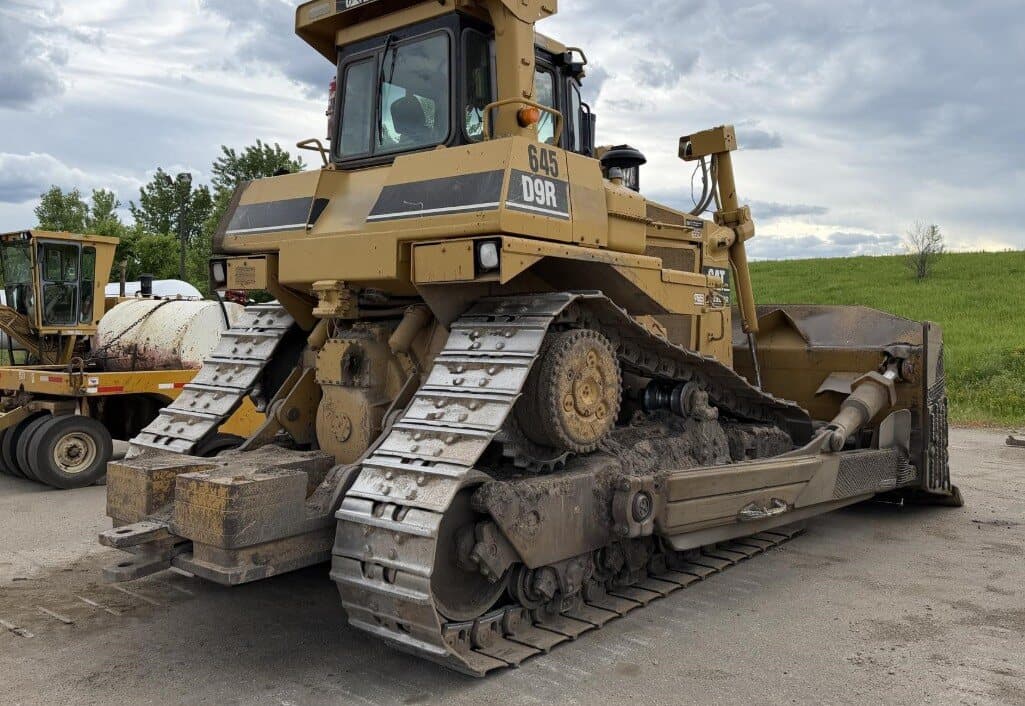 The rear of a used Caterpillar D9R showing final drives and counterweights